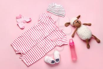 Baby clothes and accessories on color background�