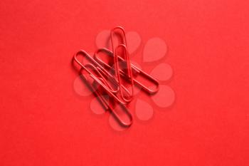 Paper clips on color background�