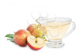 Gravy boat of apple cider vinegar on white background�