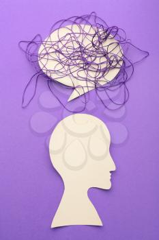 Human head and speech bubble and threads on color background. Concept of depression�