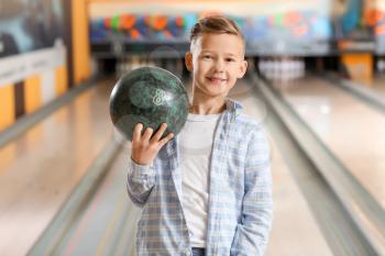 Little boy playing bowling in club�