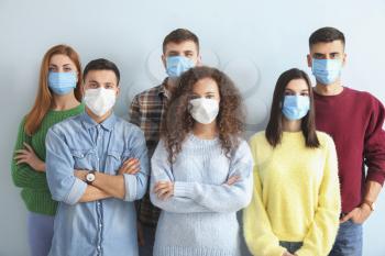 Group of people with protective masks on light background. Concept of epidemic�