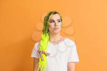 Portrait of young transgender woman on color background�