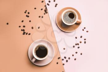 Cups of hot coffee on color background�