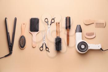 Set of hairdresser's accessories on color background�