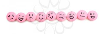 Pills with different drawn faces on white background�