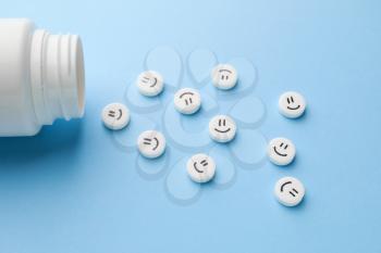 Pills with drawn faces on color background�