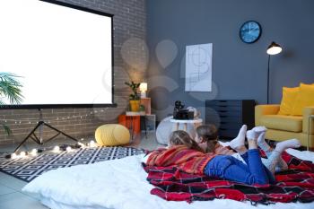 Little girls watching movie at home�
