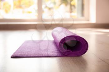 Yoga mat on floor indoors�