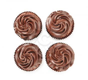 Tasty chocolate cupcakes on white background, top view�