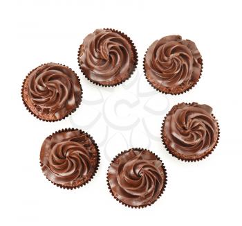 Tasty chocolate cupcakes on white background, top view�