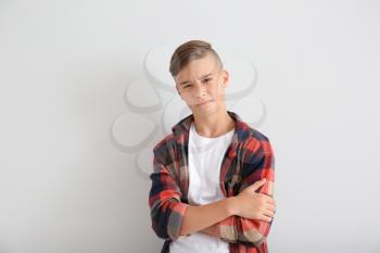 Frowning teenage boy on white background�