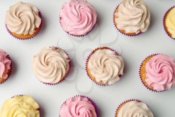 Delicious cupcakes on white background, flat lay�
