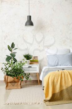 Stylish interior of bedroom with houseplants�