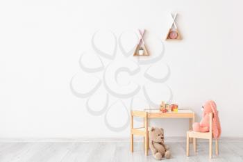 Table with chairs and toys in children's room�