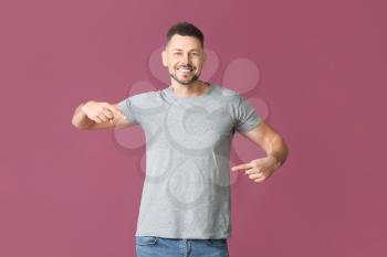 Man in stylish t-shirt on color background�