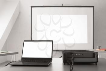 Video projector with laptop on table in conference hall�