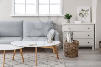 Wicker basket with sofa and table in room�