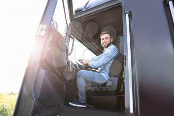 Male driver in cabin of big truck�