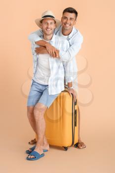 Couple of gay tourists on color background�