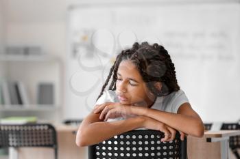 Sad African-American girl at school. Stop racism�