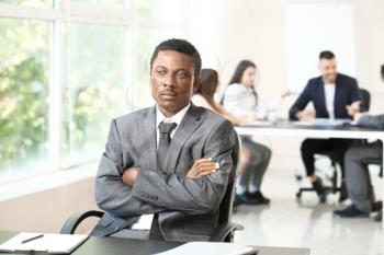 Lonely African-American businessman in office. Stop racism�