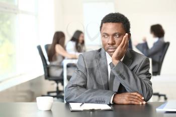 Lonely African-American businessman in office. Stop racism�
