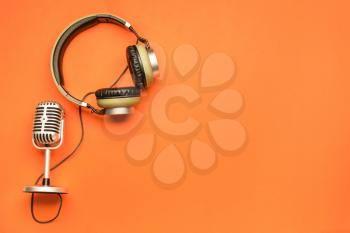 Headphones with microphone on color background�
