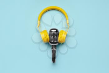 Headphones with microphone on color background�