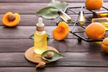 Bottle of apricot essential oil on table�