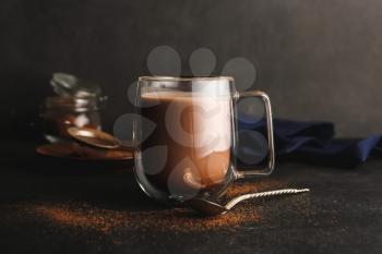 Glass cup of tasty cocoa drink on table�