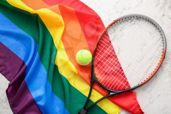 Rainbow LGBT flag and tennis racket with ball on light background�