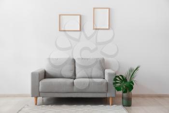 Stylish sofa in interior of living room�