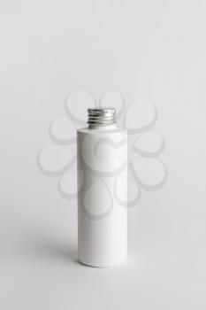 Bottle with cosmetic product on light background�