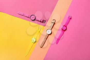 Stylish wrist watches on colorful background�