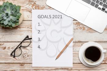 Empty to do list on 2021 year with laptop and cup of coffee on wooden background�