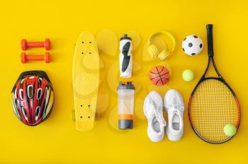 Set of sport equipment on color background�