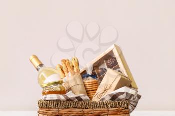 Gift basket with products on light background�