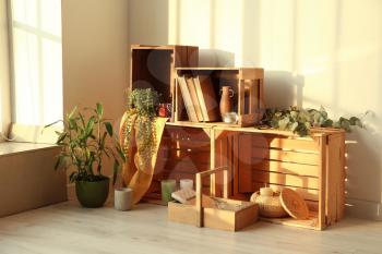 Wooden boxes with stylish decor in room�