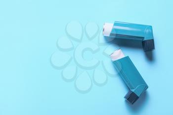 Modern inhalers on color background�