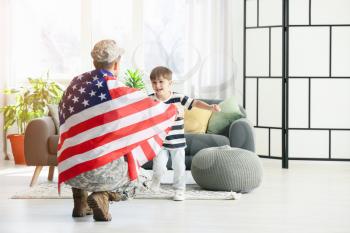 Little boy meeting his military father at home. Memorial Day celebration�