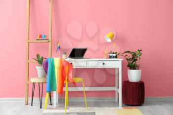 Modern workplace with flag of LGBT hanging on chair�
