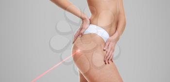 Young woman before and after treatment by laser on grey background�