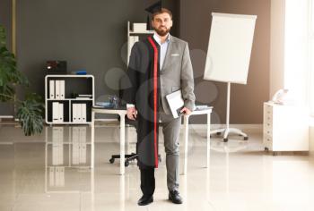 Comparison portrait of young man in bachelor robe and formal clothes in office�