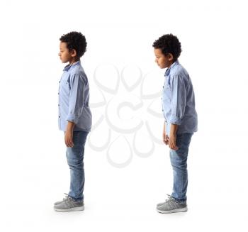 Little African-American boy with proper and bad posture on white background�
