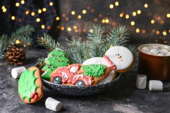 Plate with tasty Christmas cookies on dark table�