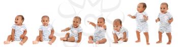 Cute African-American baby learning to walk on white background�