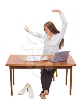 Royalty Free Photo of a Girl at a Laptop Stretching