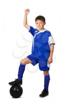Royalty Free Photo of a Young Boy in a Football Uniform With His Foot on the Ball