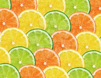 Slices of fresh citrus fruits isolated on white background 
